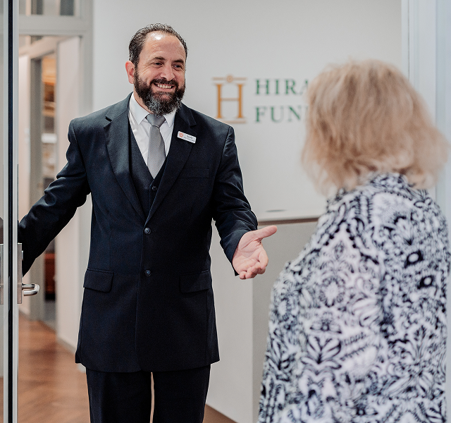 Hiram Philp funeral director greeting a woman
