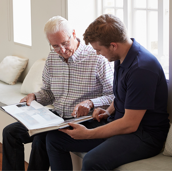 two men looking a photo album