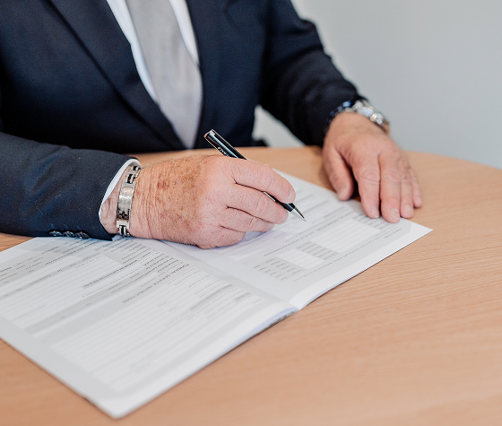 Hiram Philp funeral director writing on a document
